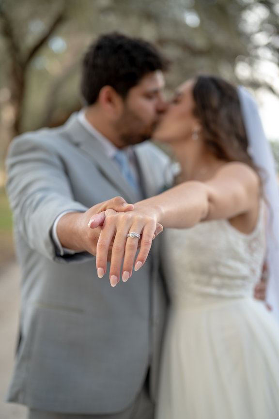 Bride and groom embracing closely in a wedding portrait.