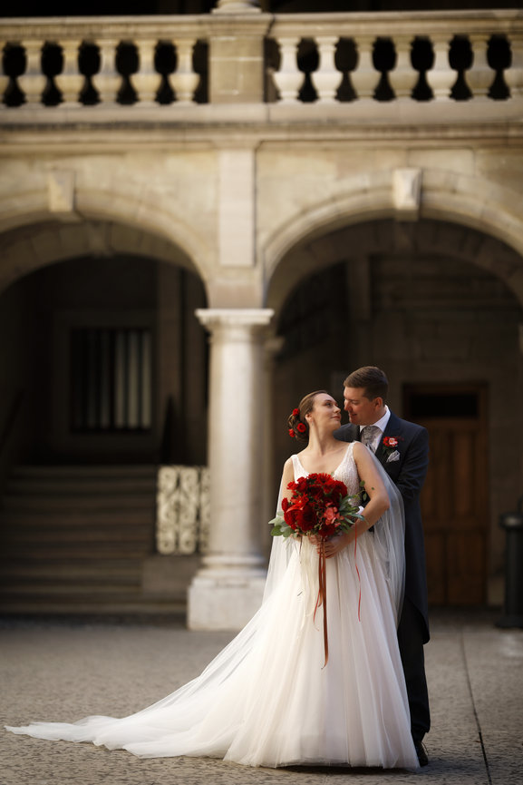 Bride and groom embracing in a historic stone courtyard in Geneva Old Town, Switzerland