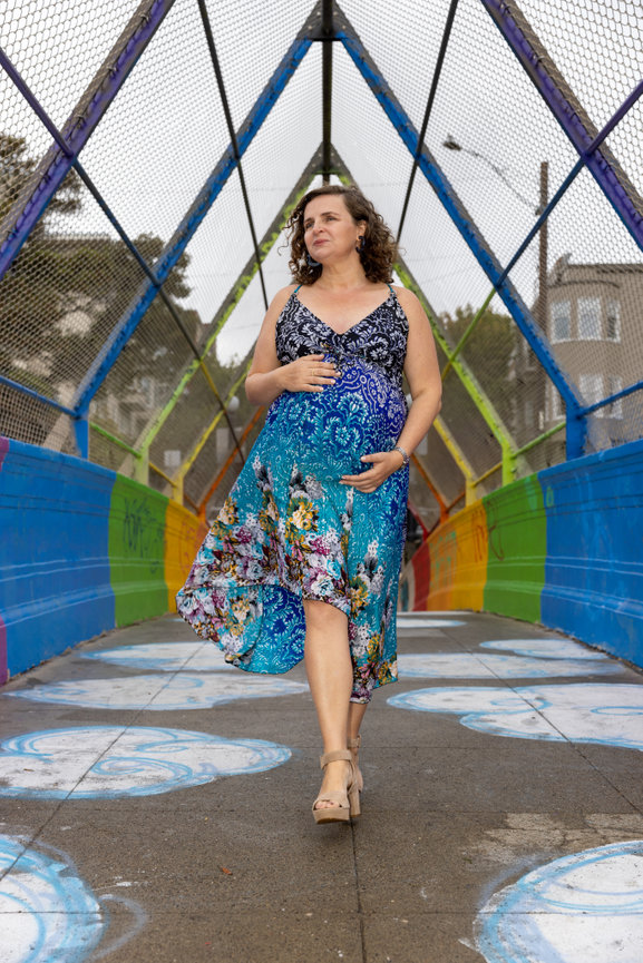 Woman walking on a rainbow bridge in San Francisco.