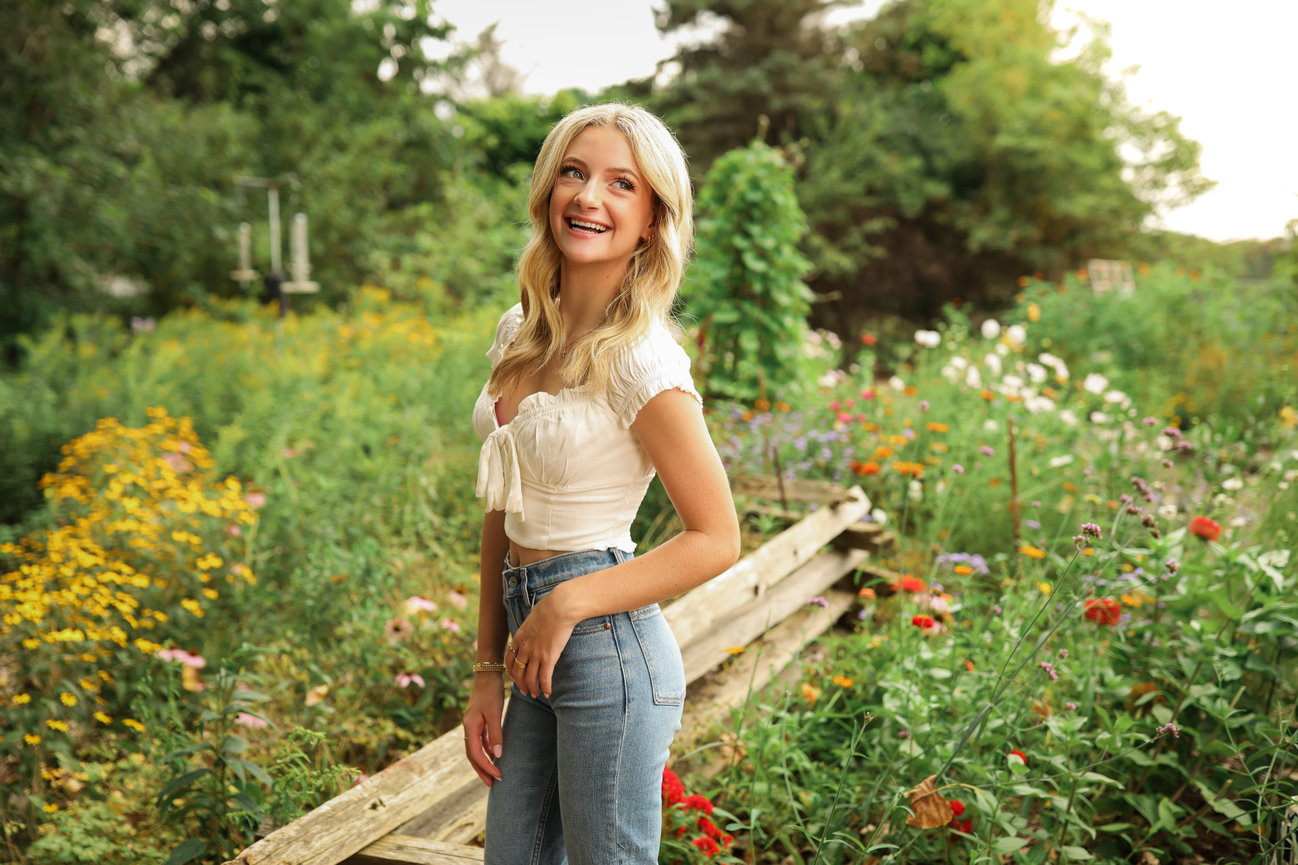 High school senior smiling outdoors during a Farmington senior photography session