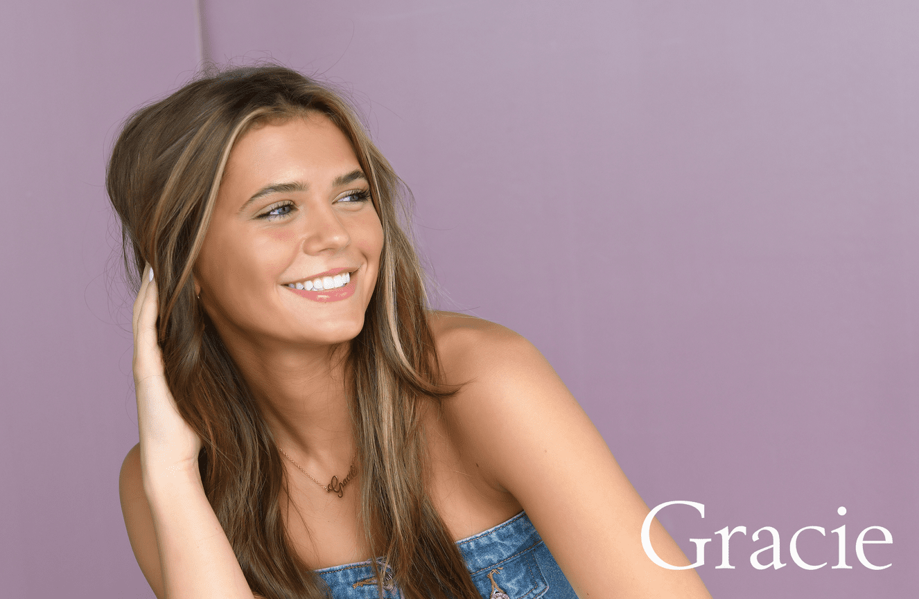 Gracie smiles off into the horizon at Kliks Photography.