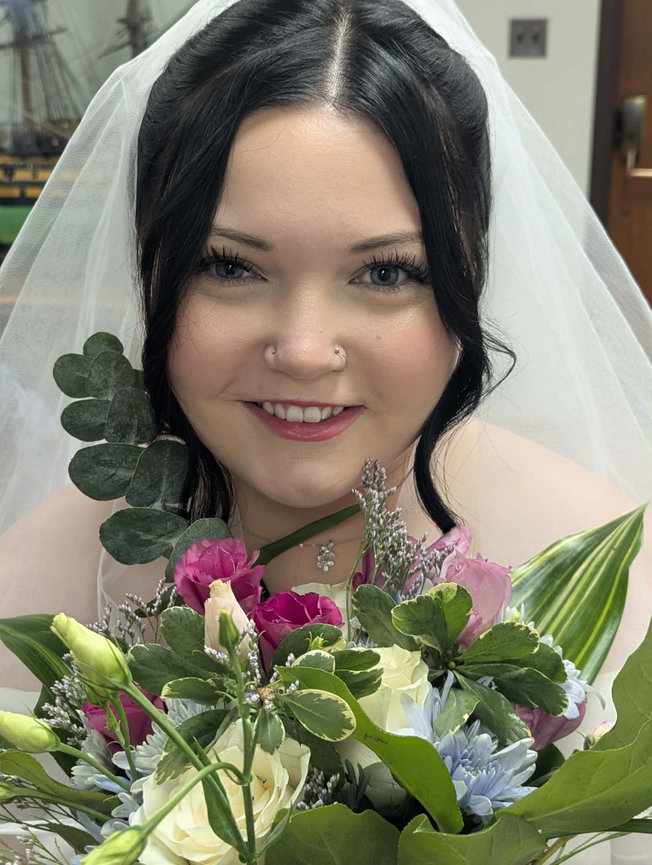 Close-up portrait of a bride holding a bouquet