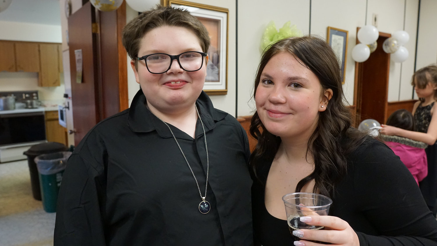 Two guests smiling at a wedding reception