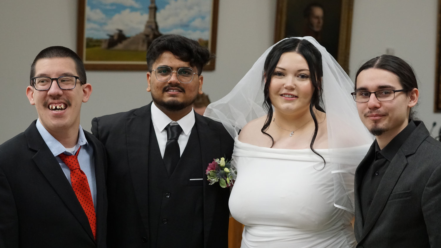 Wedding couple posing with friends during the ceremony